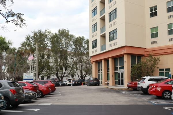 Exterior view of Sterling Aventura with parking area