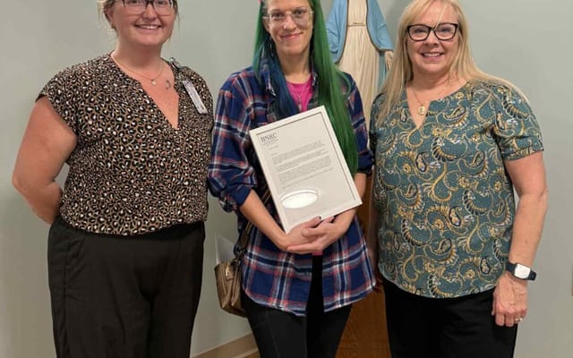 Staff members presenting an award to a resident