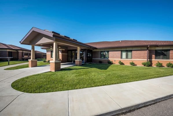 Exterior view of a senior living facility with landscaped grounds