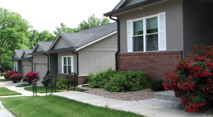 Exterior view of a senior living facility with landscaping