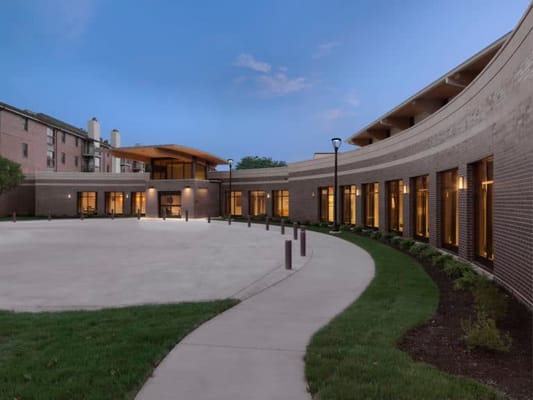 Exterior view of a senior living facility at dusk