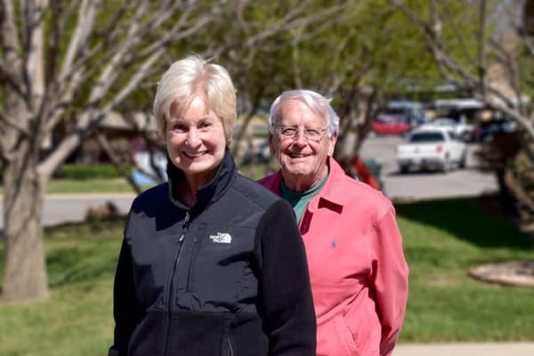 Two smiling residents enjoying the outdoor space