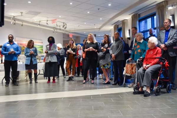 Residents and staff gathered at an event in a common area