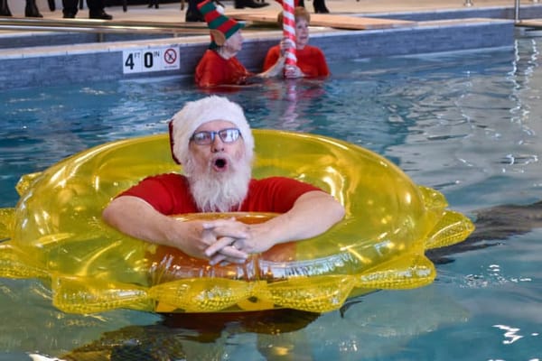 Residents enjoying a festive swim activity with Santa