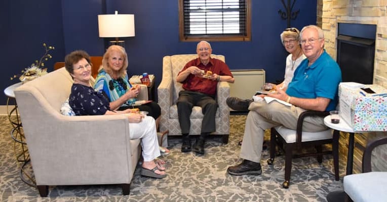 Residents enjoying refreshments in a cozy lounge area
