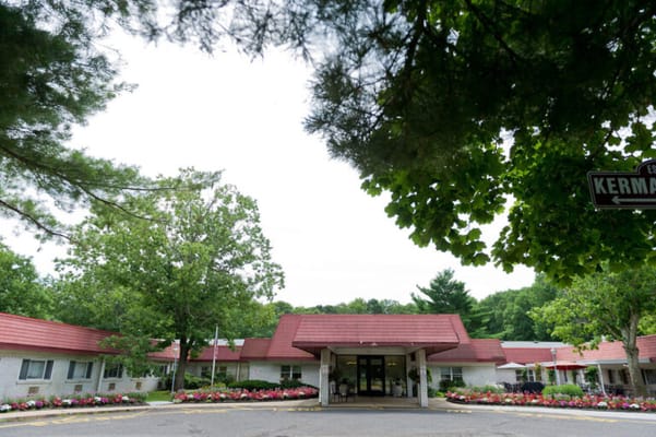Exterior view of a senior living facility surrounded by greenery