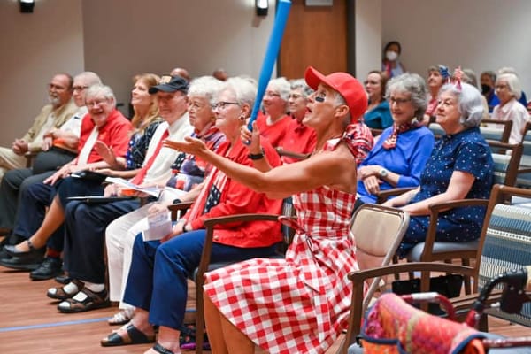 Residents enjoying an entertaining event in a community room