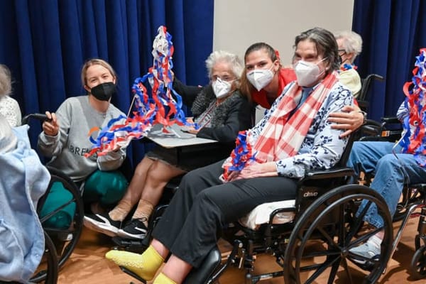 Residents and staff celebrating with crafts