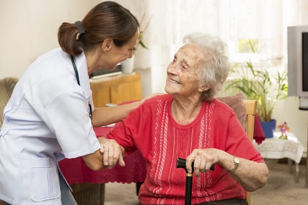 Nurse interacting with a smiling elderly resident