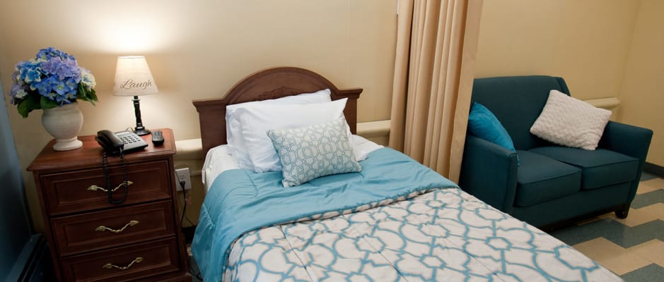 Cozy resident bedroom with blue bedding and flowers