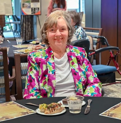 Resident enjoying a meal at a dining event