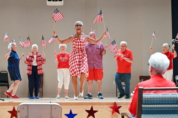 Residents participating in a lively group activity with flags