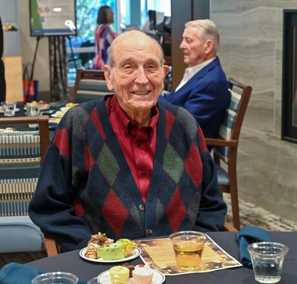 A resident enjoying a meal in the dining room