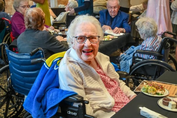 Smiling resident enjoying a meal at a communal activity