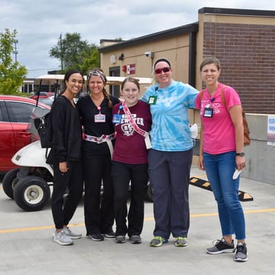 Staff members posing outside the facility