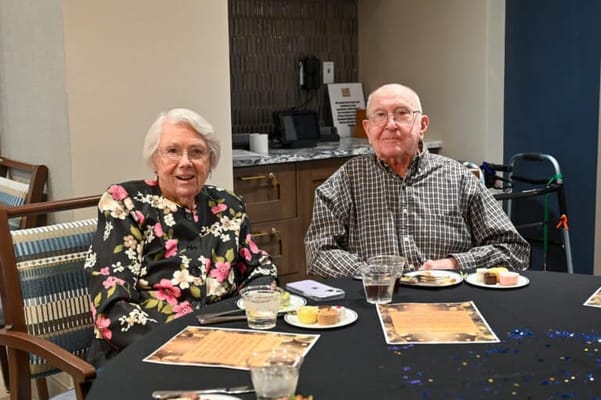 Two residents enjoying a meal together at a dining table