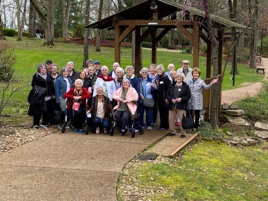Group of residents posing outside in a garden area