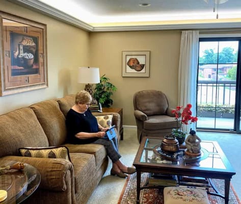 A resident reading comfortably in a living room