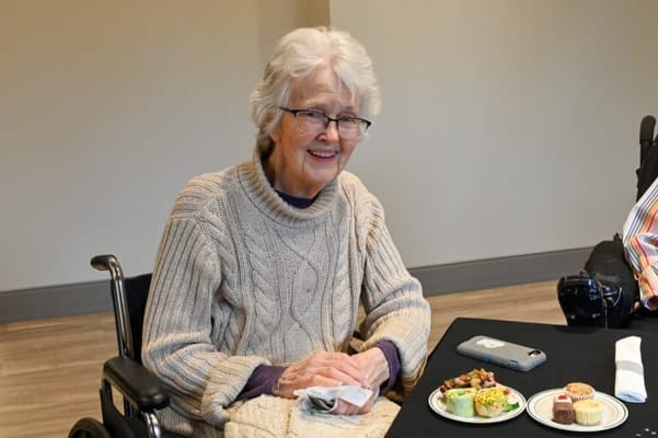 A resident enjoying snacks in a cozy indoor setting