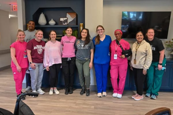 Staff members posing together in a common area