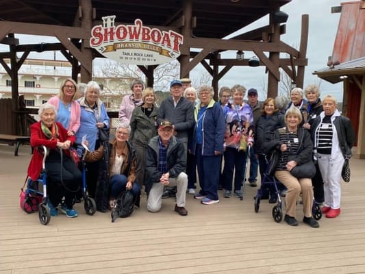 Residents and staff posing in front of the Showboat