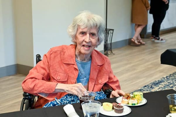 Senior resident enjoying a meal at a gathering