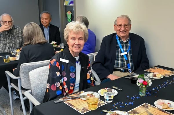 Residents enjoying a meal at a dining table