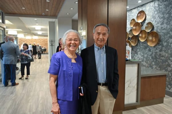 Happy couple posing inside the facility reception area