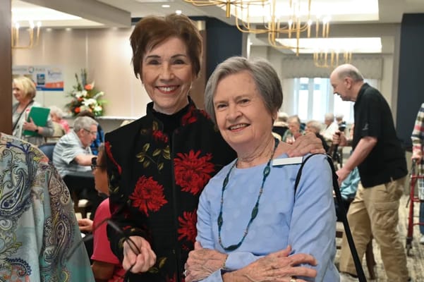 Two residents smiling during a community event