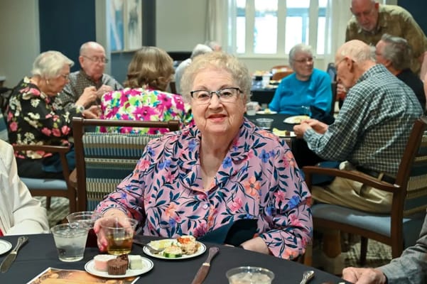 Residents enjoying a meal together in the dining room