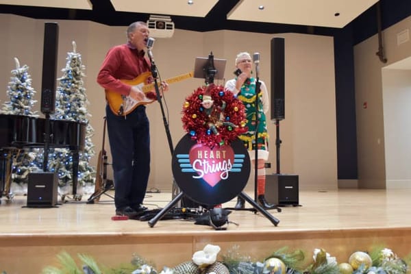 Residents enjoying a musical performance in a common area