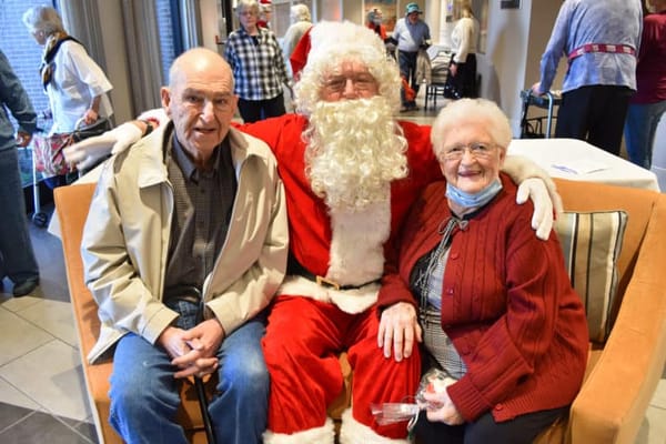 Residents celebrating with Santa Claus during a holiday event