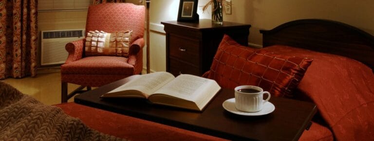 Cozy bedroom with a book and a cup of coffee