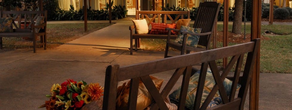 Outdoor seating area with flowers and cushions