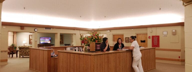 Reception area with staff and residents interacting