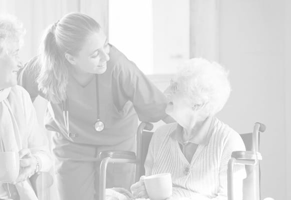 Nurse interacting with elderly residents over tea