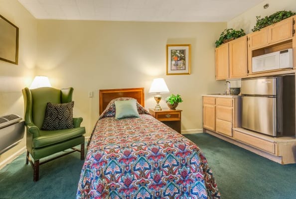 Cozy resident room with a bed and kitchenette