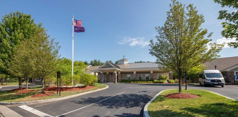 Building exterior with landscaped area and flagpole