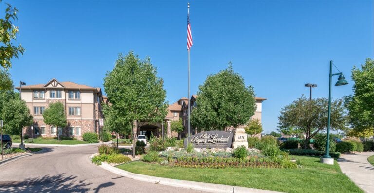 Entrance to a senior living facility with landscaped grounds