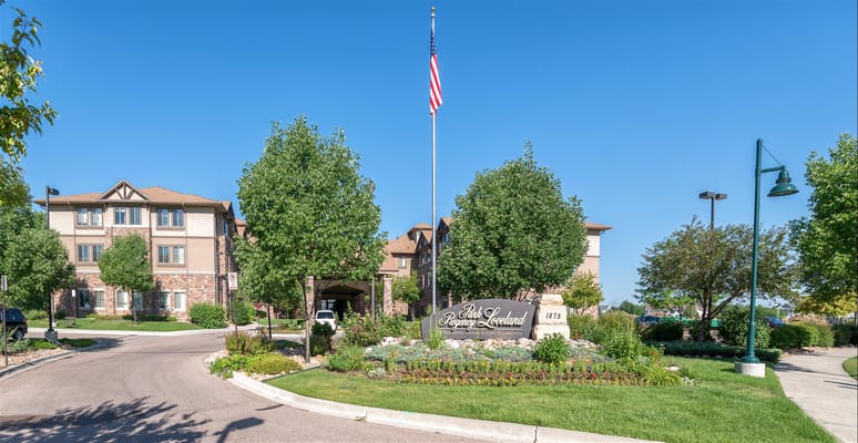 Entrance to a senior living facility with landscaped grounds
