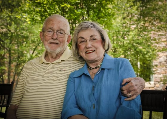 Smiling couple sitting outdoors in a garden
