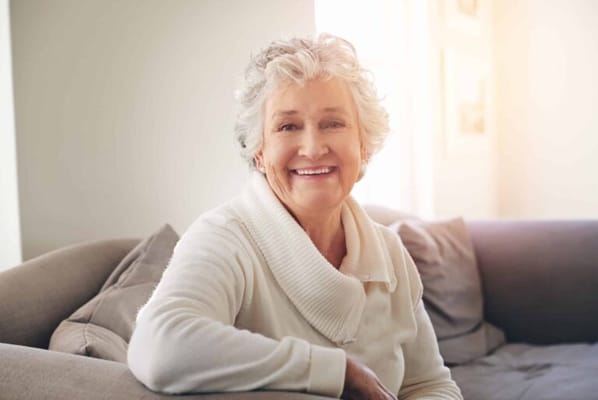 Smiling senior woman relaxing on a sofa