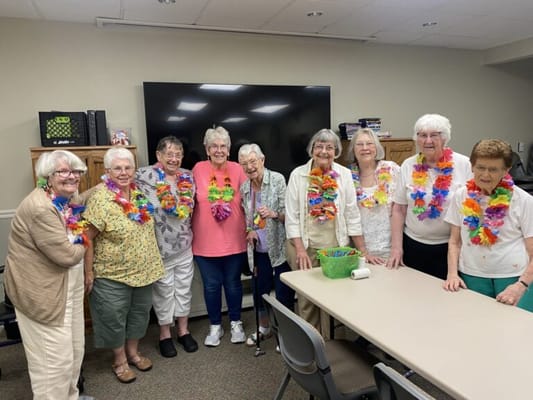 Residents celebrating with leis in a common area