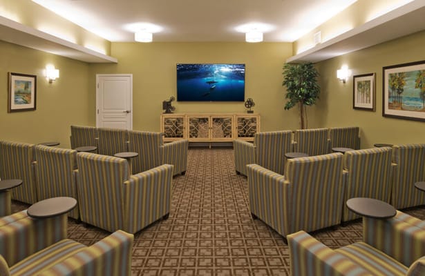 Bright common area with colorful seating and TV