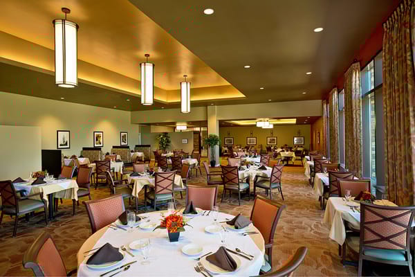 Elegant dining room with tables set for a meal