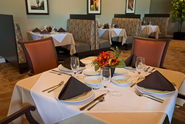 Table set for dining with floral centerpiece