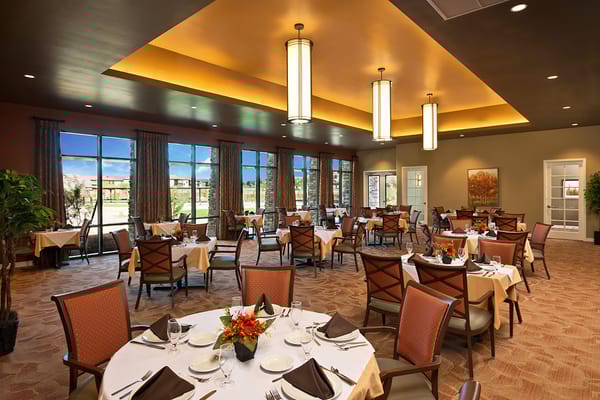 Tastefully set dining room with large windows