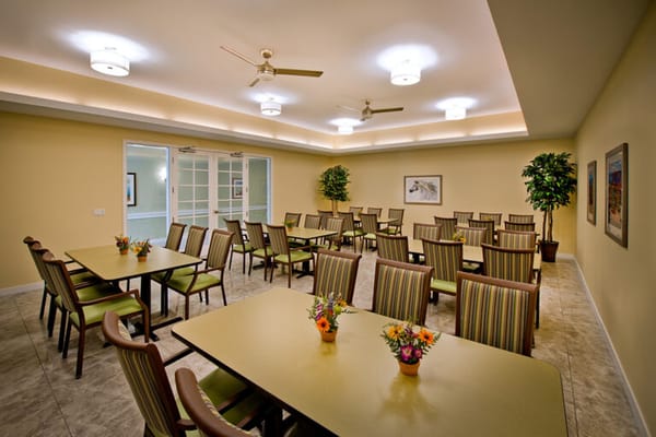 Bright dining room with tables and flowers