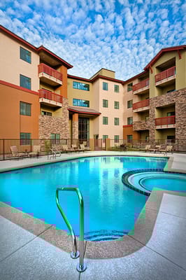 Swimming pool area surrounded by the facility building