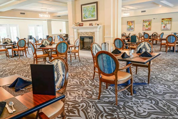 Dining room with well-set tables and decorative fireplace